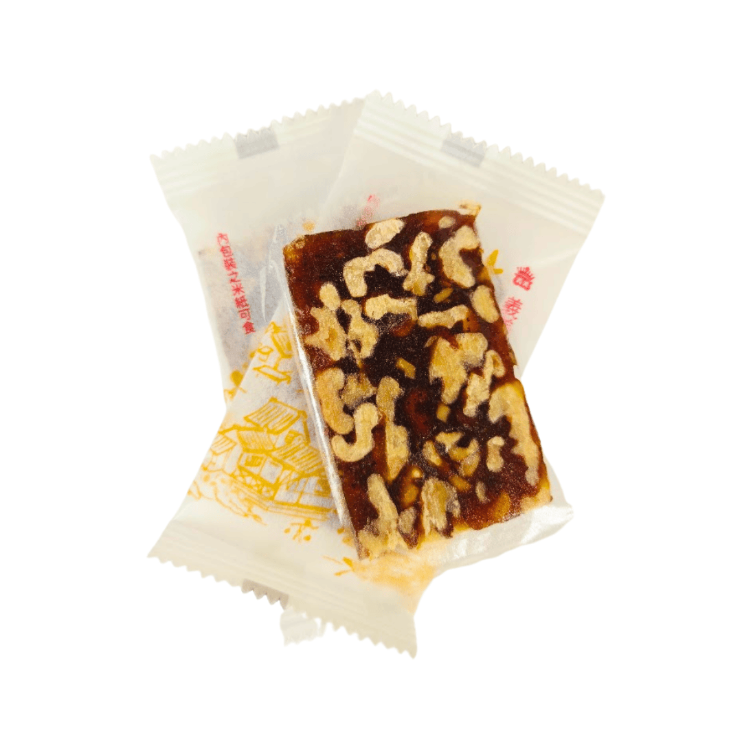 Walnut date thin bar snack from Taiwan on top of two wrapped snack bars