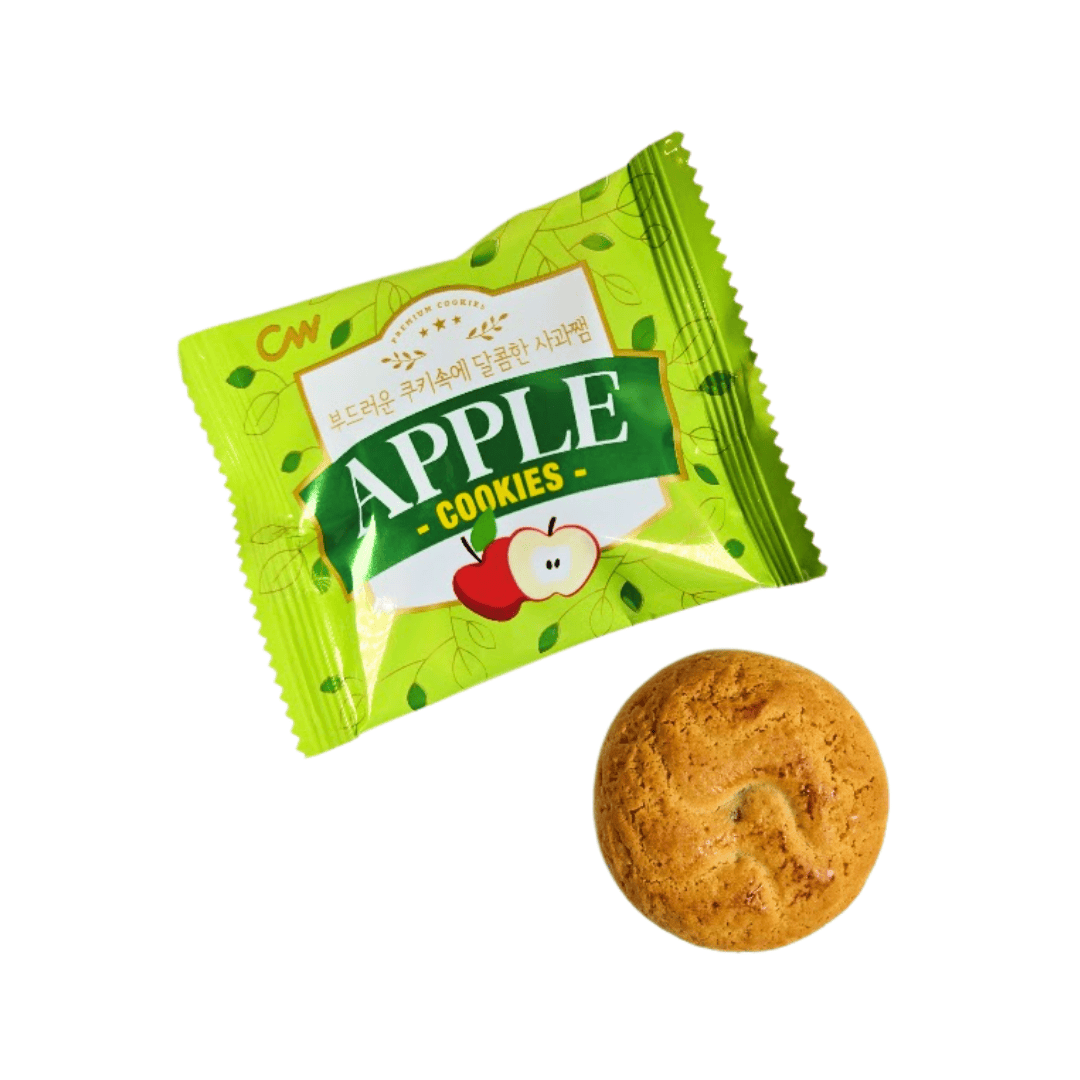 A round apple cookie below a green wrapper with an apple illustration on the front.