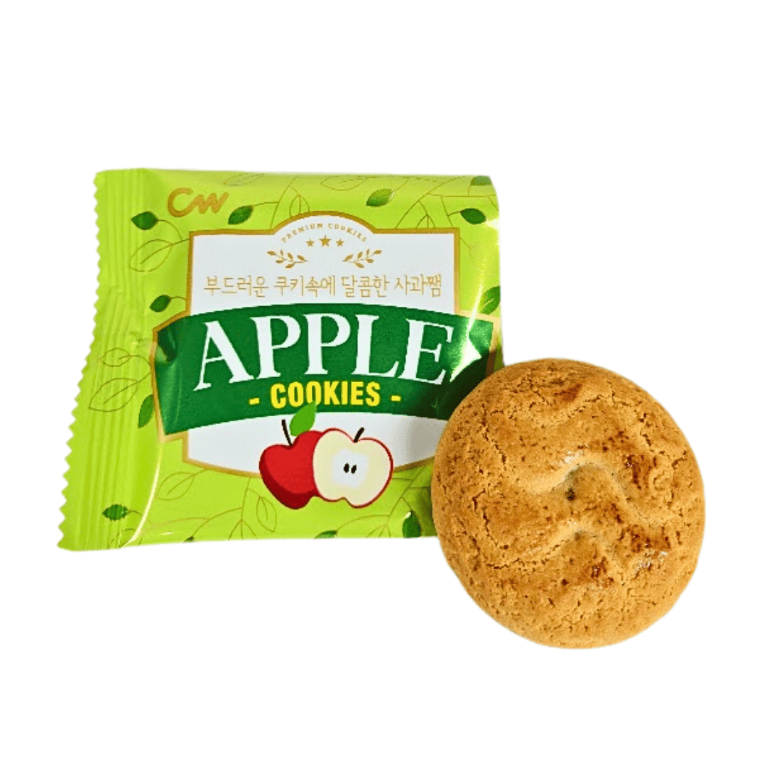 Apple cookie next to a green wrapper with an apple illustration on the front.