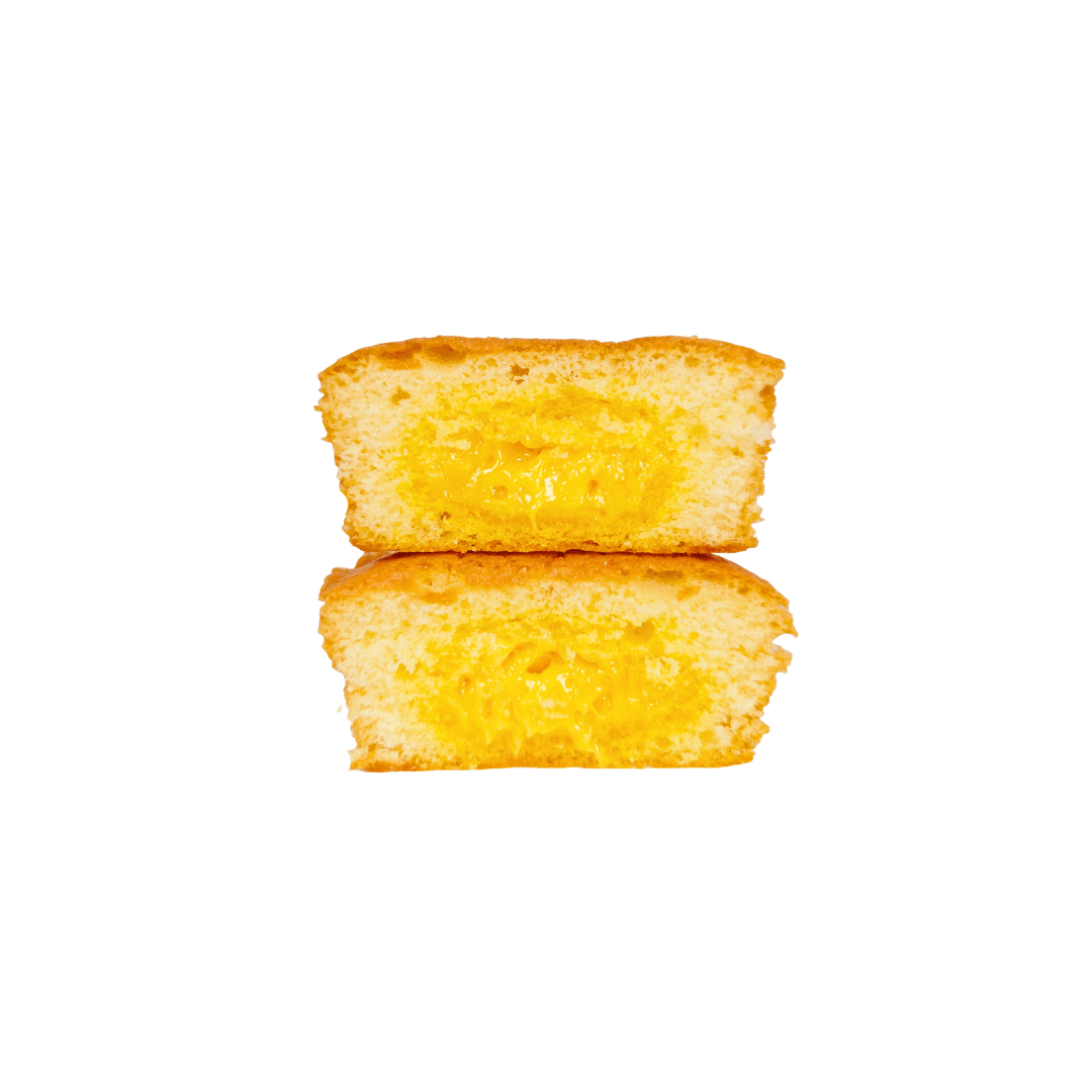Two pieces of the custard soft cake on a white background