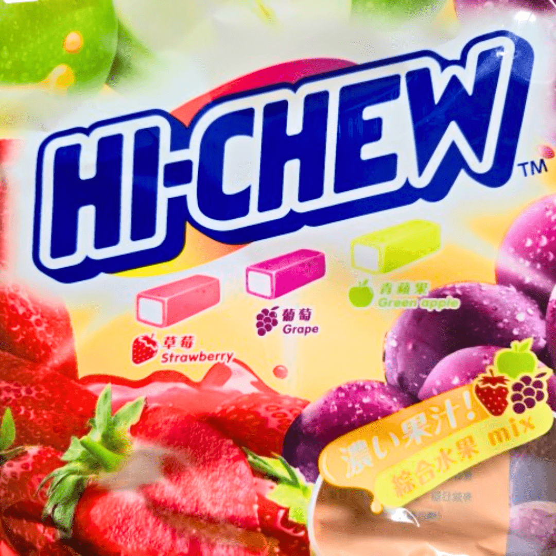 A colorful package of Hi-Chew candy featuring images of strawberry, grape, and green apple flavors, with text indicating the flavors in both English and Chinese.