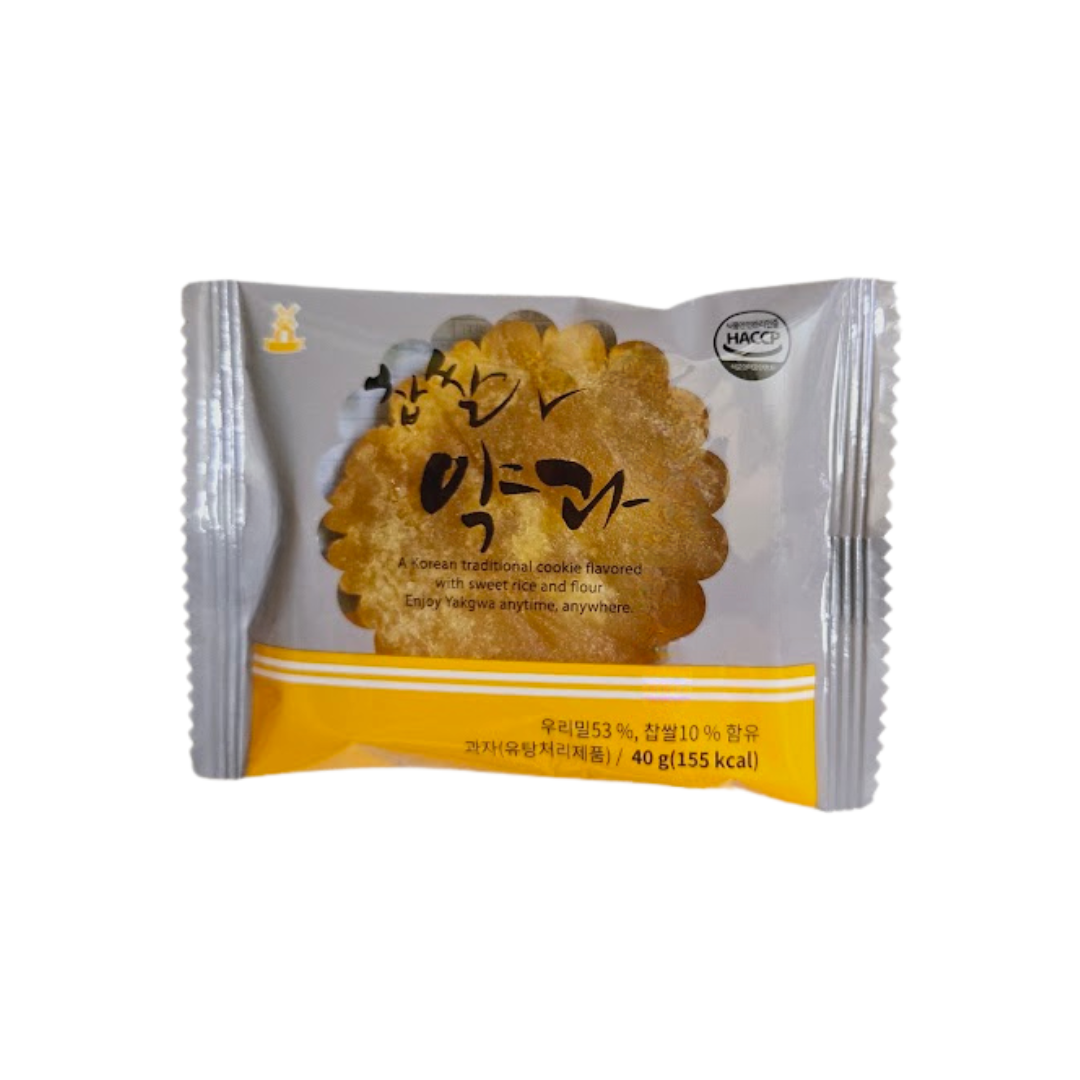 A package of a Korean traditional cookie called Yakgwa. The packaging is silver and yellow, with a clear image of the cookie inside. Text on the package reads: 'A Korean traditional cookie flavored with sweet rice and flour. Enjoy Yakgwa anytime, anywhere.' The net weight is 40g (155 kcal).