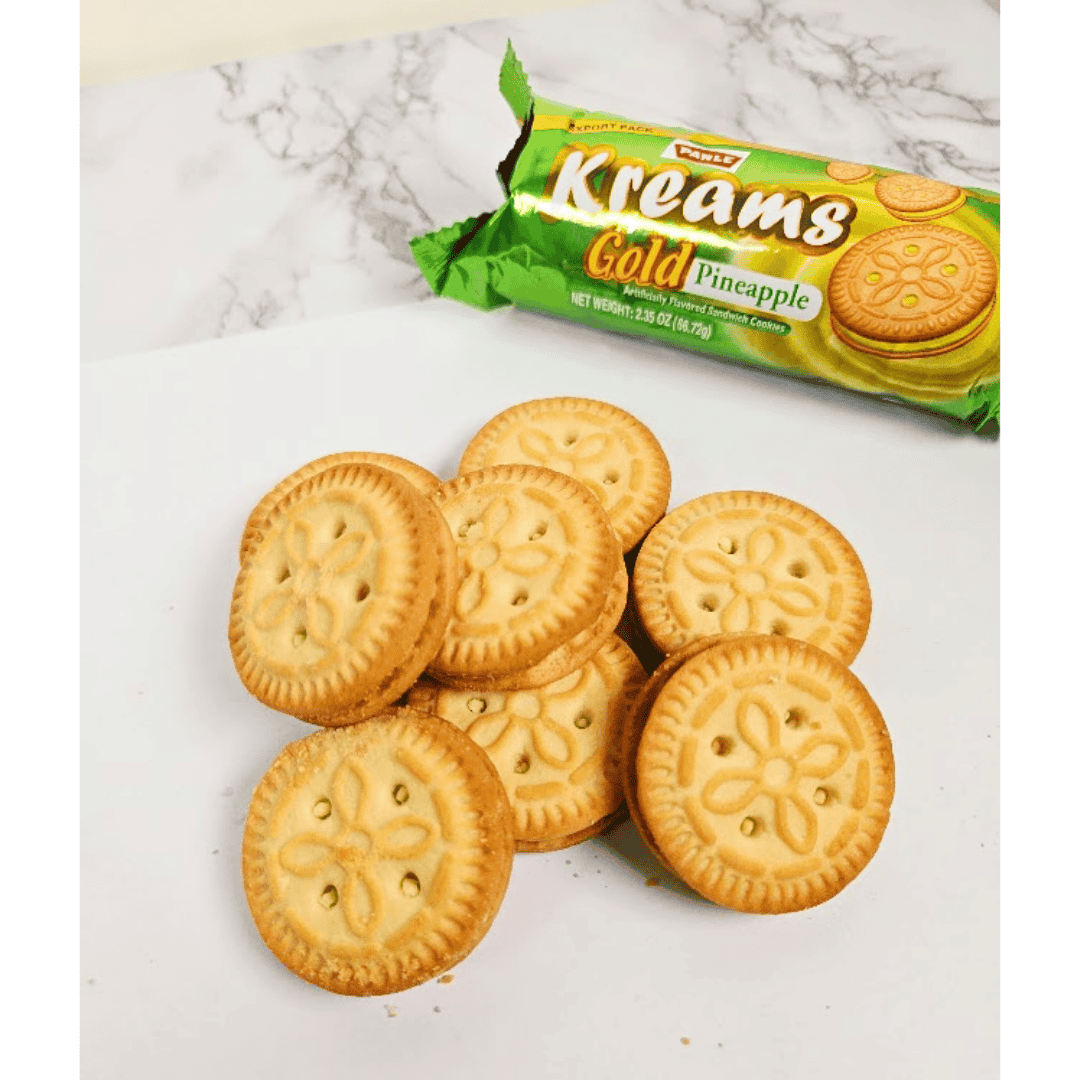 Kreams Gold Pineapple cookies on a marble surface with packaging in the background
