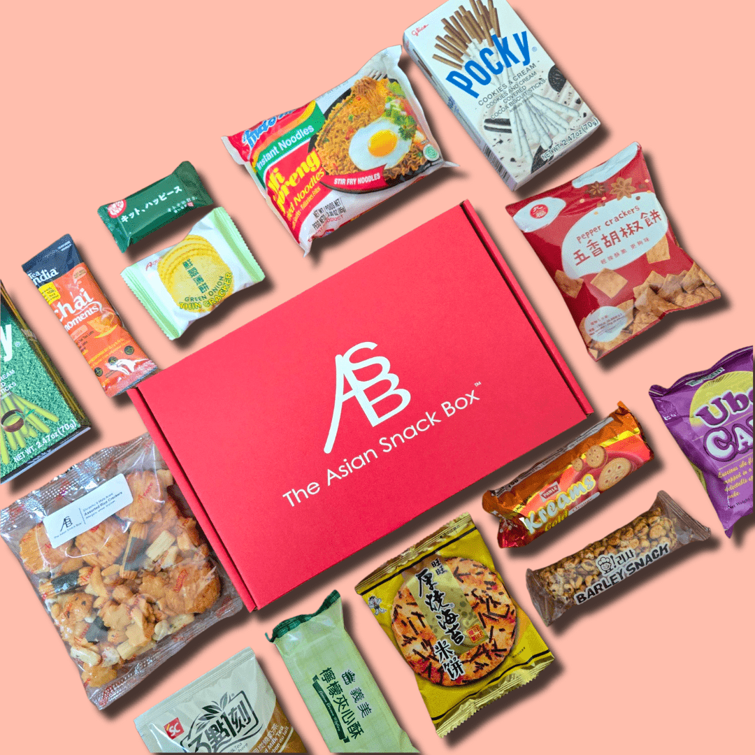 A red The Asian Snack Box surrounded by Asian snacks