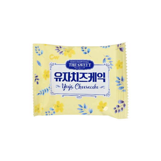 Yellow package of Yuja Cheesecake with floral designs on a white background